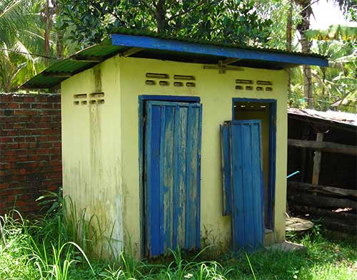a cambodian outhouse at a pig farm
